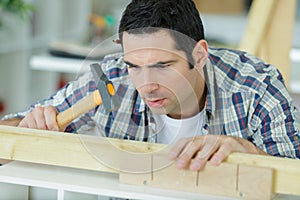 hammering nails into wooden planks