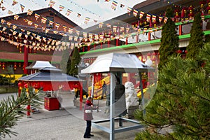 Hammering the traditional Asian big ceremony bronze bell in the temple in the Buddhist temple in Toronto, Ontario, Canada