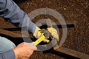 Hammering wood pieces for trellis