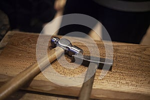 Hammers are on a wooden table. Tools in a carpentry workshop.