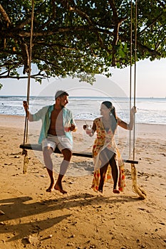 Hammock on the beach Krabi Thailand, couple in swing on Ao Nang beach Thailand Krabi