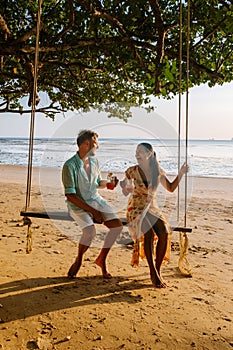 Hammock on the beach Krabi Thailand, couple in swing on Ao Nang beach Thailand Krabi