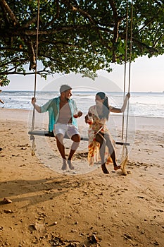 Hammock on the beach Krabi Thailand, couple in swing on Ao Nang beach Thailand Krabi