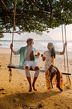 Hammock on the beach Krabi Thailand, couple in swing on Ao Nang beach Thailand Krabi