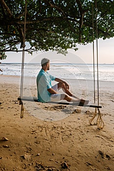 Hammock on the beach Krabi Thailand, guy in swing on Ao Nang beach Thailand Krabi