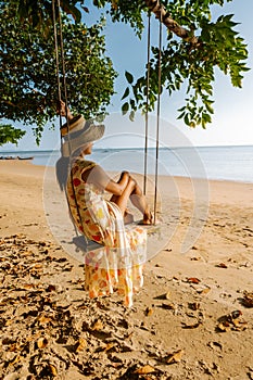 Hammock on the beach Krabi Thailand,woman in swing on Ao Nang beach Thailand Krabi