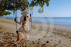 Hammock on the beach Krabi Thailand,woman in swing on Ao Nang beach Thailand Krabi