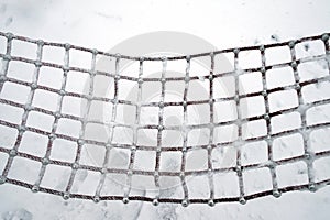 A hammock covered with snow.