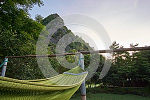 Hammock in front of a mountain in a backpacker hostel in the town of Phong Nha in the National Park of Phong Nha Ke Bang