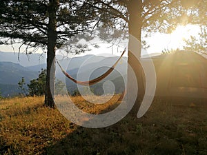 Hammock on mountain at sunset