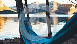 Hammock for relaxing on background of nature lake, chilling outdoor, traveler recreation mountain landscape; camping lifestyle