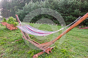 Hammock in summer garden of country house at morning