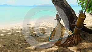 Hammock on summer sea beach with turquoise water