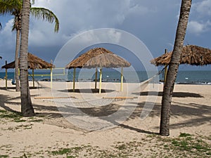 Hammock, Tiki Huts, and Volleyball Net on the Beach