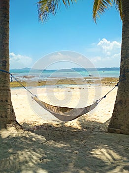 Hammock on a tropical island with view of the sea