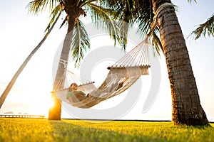 Hammock on tropical palm trees overlooking the mountains