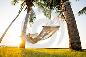 Hammock on tropical palm trees overlooking the mountains