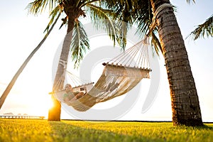 Hammock on tropical palm trees overlooking the mountains