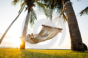 Hammock on tropical palm trees overlooking the mountains