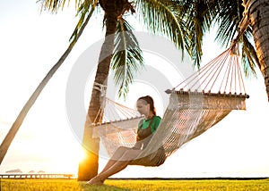 Hammock on tropical palm trees overlooking the mountains