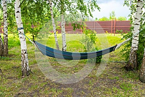 Hammock between two trees in the courtyard of the house