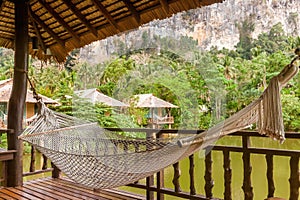 Hammock in wooden house with mountain and lake view in a nature resort