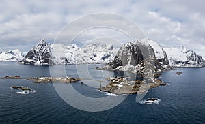 Hamnoy Fishing Village, Festhelltinden and Olstinden Mountain in Winter. Lofoten Islands, Norway. Aerial Panoramic View