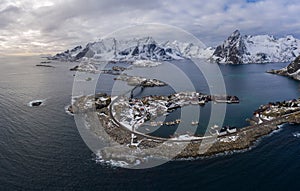 Hamnoy Village and Mountains in Winter. Norwegian Sea and Stormy Sky. Moskenes, Lofoten Islands, Norway. Aerial View photo