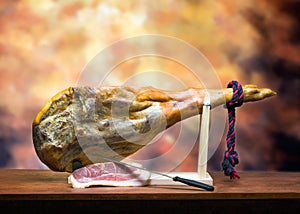 Hamon - leg of dried pork meat - on a wooden stand. photo