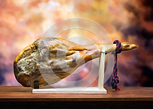 Hamon - leg of dried pork meat - on a wooden stand. photo