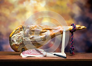 Hamon - leg of dried pork meat - on a wooden stand. photo