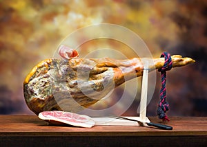 Hamon - leg of dried pork meat - on a wooden stand. photo