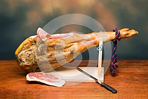 Hamon - leg of dried pork meat - on a wooden stand. photo