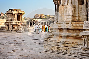 Hampi, India - 19 November 2014: People walking in front of stone chariot in courtyard of Vittala Temple in Hamp