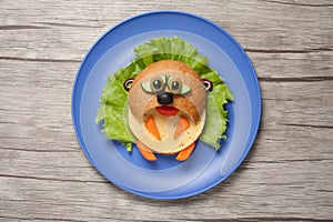 Hamster made of bread and vegetables on table