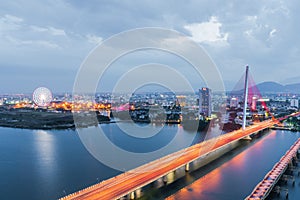 Han River Bridge Cau Song Han over the Han River in Da Nang, central Vietnam. Da Nang skyline cityscape by twilight period