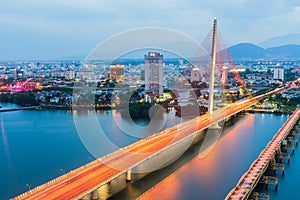 Han River Bridge Cau Song Han over the Han River in Da Nang, central Vietnam. Da Nang skyline cityscape by twilight period