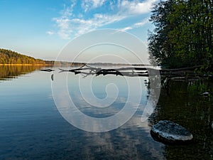 Hancza Lake, the deepest lake of the Poland. Sunny day, late afternoon, sky reflecting in the water.