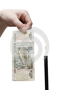A hand with a 10 rouble banknote and a gas lighter