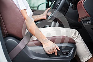 Hand adjust car seat before drive on the road . Ergonomic and safety transportation concept