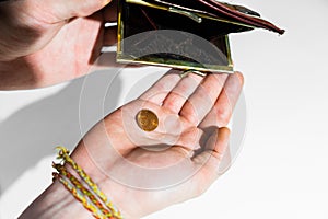 The hand of an adult holds cents in the palm