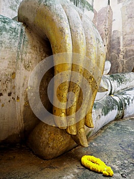 Hand of ancient Buddha statue.