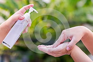Hand applying alcohol spray or anti bacteria spray to prevent spread of germs, bacteria and virus. Gel rub clean hands hygiene pre