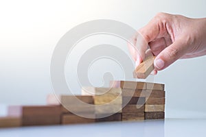 Hand aranging wood block stacking as step stair.