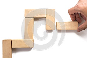 Hand aranging wood block stacking as step stair.
