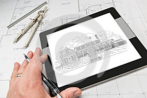 Hand of Architect on Computer Tablet Showing Home Illustration O