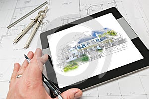 Hand of Architect on Computer Tablet Showing Home Illustration O