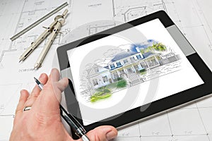 Hand of Architect on Computer Tablet Showing Home Illustration O photo