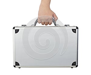 Hand and arm holding silver luggage or brief case isolated on wh