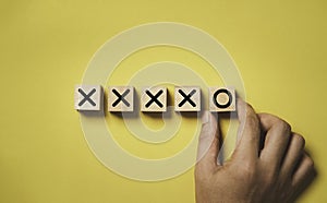 Hand arrange circle sign from cross sign on wooden block cube for fail to success and effort positive mindset concept